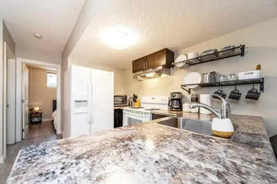 a kitchen with a sink and a counter top at Bright Modern Suite - Netflix - WiFi - Long Stays in Edmonton