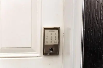 a remote control on a door with a window at Bright Modern Suite - Netflix - WiFi - Long Stays in Edmonton