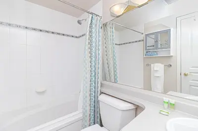 a bathroom with a toilet and a sink and a mirror at Harbour Retreat in Victoria