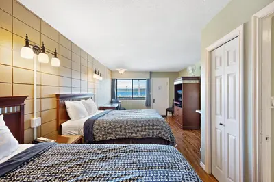 a hotel room with two beds and a window at Big Rock Motel in Campbell River