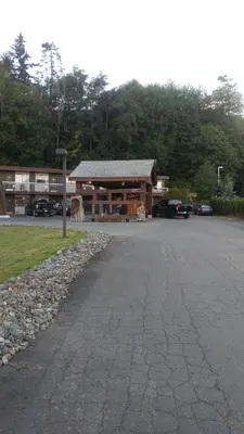 a building with a parking lot in front of it at Big Rock Motel in Campbell River