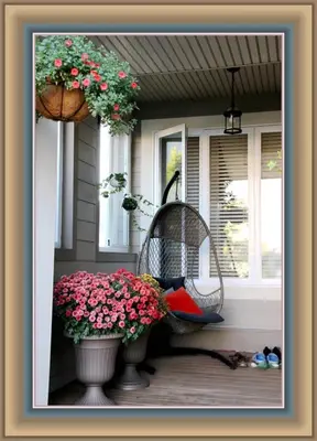 a cat sitting in a wicker chair on a porch with flowers at Scorpio House Langley -ROOM 1 Separate restroom in Pitt Meadows