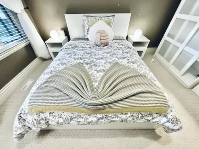 a bed with a blanket on it in a bedroom at Scorpio House Langley -ROOM 1 Separate restroom in Pitt Meadows