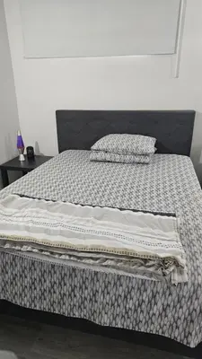 a bed with two pillows on top of it at Bright and Cozy Room with Free Parking in Edmonton