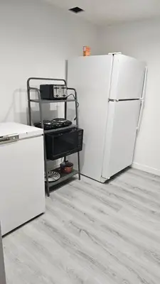 a kitchen with two white refrigerators in a room at Bright and Cozy Room with Free Parking in Edmonton