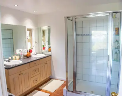 a bathroom with two sinks and a shower at Armand Heights in Ganges