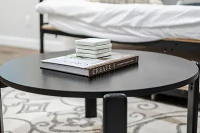a coffee table with books on top of it at Stylish Suite-NearWEM-4 Bed-Central in Edmonton
