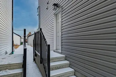 a stairway leading to a door of a house at Stylish Suite-NearWEM-4 Bed-Central in Edmonton