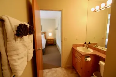 a bathroom with a sink and a mirror at Timberline Condos - Aspen Building in Fernie