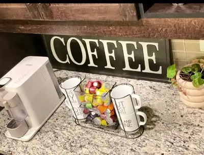 a coffee machine and cups on a counter at Best home with lake view in Edmonton