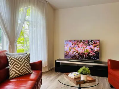 a living room with a couch and a flat screen tv at Beautiful home with one acre land for leisure time in Vancouver Island in Nanaimo