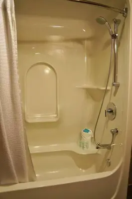 a shower in a bathroom with a shower curtain at Gracie's Place Business license 11787 in Canmore