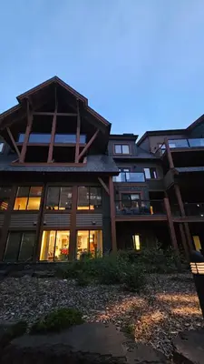a large building with many windows at dusk at Gracie's Place Business license 11787 in Canmore