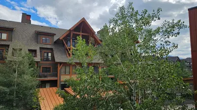 an exterior view of a house with a tree at Gracie's Place Business license 11787 in Canmore