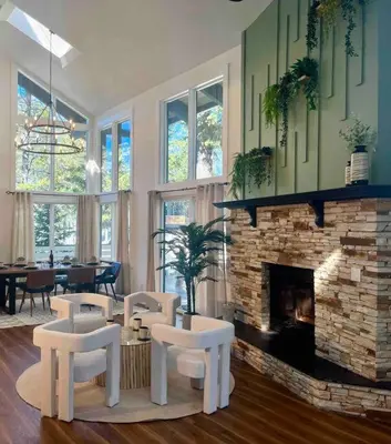 a living room with chairs and a fireplace at Verde Vista - Steam Shower - Theatre - Ping-Pong in Fairmont Hot Springs