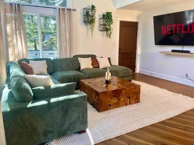 a living room with a couch and a coffee table at Verde Vista - Steam Shower - Theatre - Ping-Pong in Fairmont Hot Springs