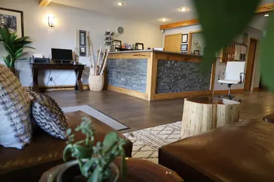 a living room with a couch and a bar at Glacier Mountain Lodge in Blue River
