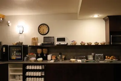 a counter with a clock on the wall in a kitchen at Glacier Mountain Lodge in Blue River