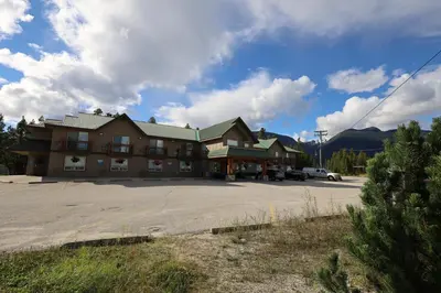 a large building with a parking lot in front of it at Glacier Mountain Lodge in Blue River