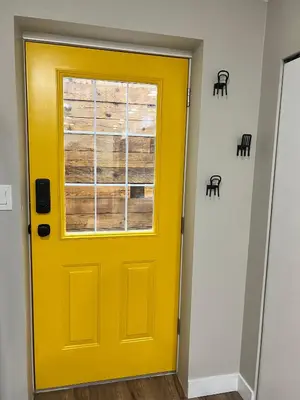 a yellow door in a room with a window at Yellow Door Suite in Campbell River