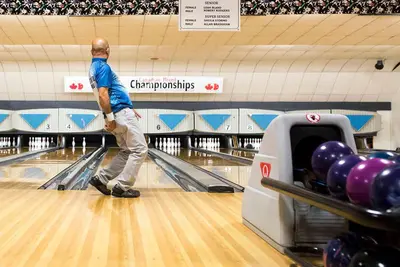 a man is bowling in a bowling alley at Yellow Door Suite in Campbell River