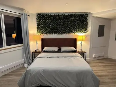 a bedroom with a large bed and two lamps at Cabin in the woods @ Cultus Lake in Chilliwack