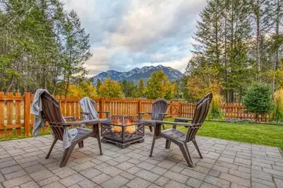 a patio with two chairs and a fire pit at Radium 5BR Home Ping Pong, Foosball, & Gazebo in Radium Hot Springs