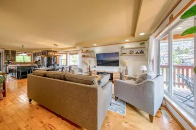 a living room with two couches and a television at Radium 5BR Home Ping Pong, Foosball, & Gazebo in Radium Hot Springs