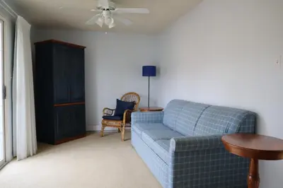 a living room with a blue couch and a table at Blue Shore Resort in Savona