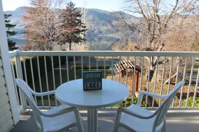 a table and chairs on a balcony with a view at Blue Shore Resort in Savona