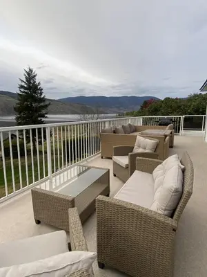 a balcony with wicker furniture and a table and chairs at Blue Shore Resort in Savona