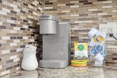 a blender sitting on a counter next to a brick wall at Large Detached Near Anthony Henday in Albany with 2 Living Rooms, Netflix, Office Space, AC, Perfect for Families, Sleeps 13 in Edmonton