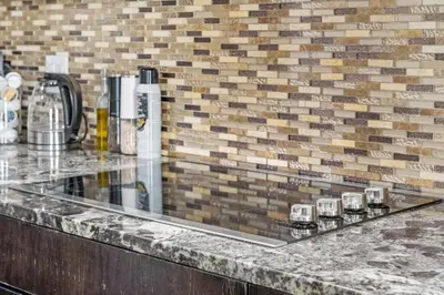 a counter with glasses on it in front of a brick wall at Large Detached Near Anthony Henday in Albany with 2 Living Rooms, Netflix, Office Space, AC, Perfect for Families, Sleeps 13 in Edmonton