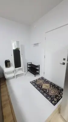 a white room with a refrigerator and a rug at Gorgeous 2 Bedrooms Suite Private entrance with patio-Free Parking in Maple Ridge District Municipality