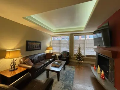a living room with a couch and a christmas tree at Luxury Resort 2Bedroom 2Bath Sleeps 6 945 square feet in Canmore