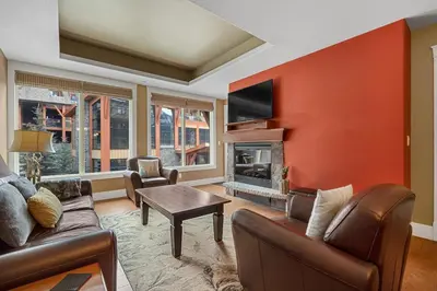 a living room with a couch and a fireplace at Luxury Resort 2Bedroom 2Bath Sleeps 6 945 square feet in Canmore