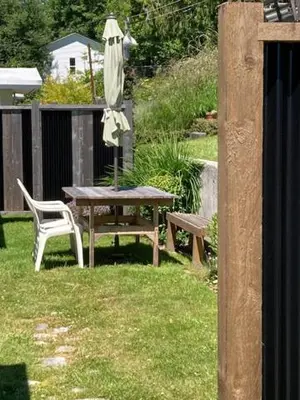 a table and a chair and an umbrella in a yard at Rent My Studio in Powell River
