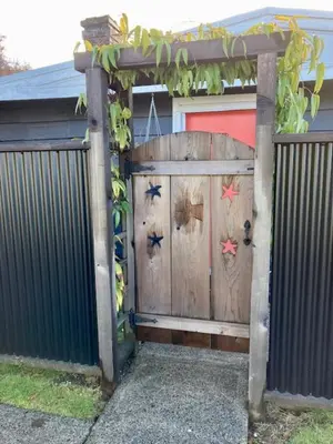 a wooden entrance to a house with a fence at Rent My Studio in Powell River