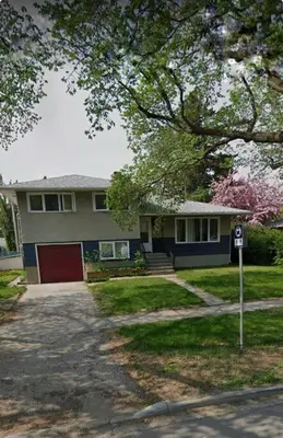 a house with a parking meter in front of it at 3 Bedroom Home away from Home in Calgary