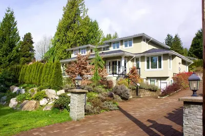 a house with a pathway in front of a yard at Welcome Home in North Vancouver