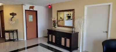 a living room with a mirror and a dresser at GRIZZLY MOTEL in Swan Hills