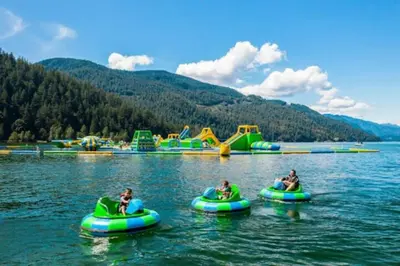 a group of people riding on tubes in the water at Mountain View Penthouse 7BR Combo Unit Bliss in Harrison Hot Springs