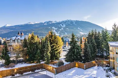 a resort with trees and a mountain in the background at Cascade Lodge in Whistler