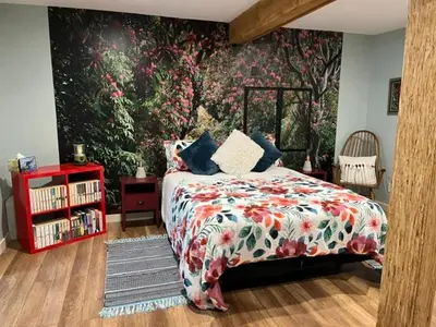 a bedroom with a bed and a large floral wall at Cottonwood#2 in Youbou