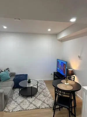 a living room with a couch and a table at Guest suite in Southwest Calgary in Calgary
