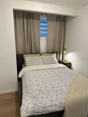 a bedroom with a bed and a window at Guest suite in Southwest Calgary in Calgary