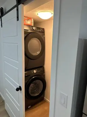 a laundry room with a washer and a washing machine at Guest suite in Southwest Calgary in Calgary