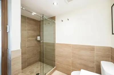 a bathroom with a shower with a glass door at Le Chamois by Outpost Whistler in Whistler