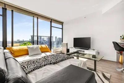 a living room with a couch and a television at Central Luxury Apartment with Best City Views! in Vancouver