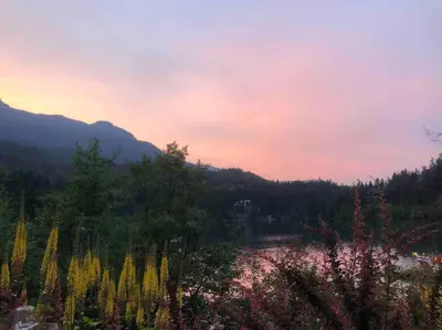 a view of a river in the mountains at sunset at Ski nest 5m to Creekside Gondola in Whistler